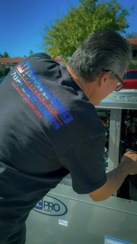 Manring technician testing the electrical components of an air conditioning unit