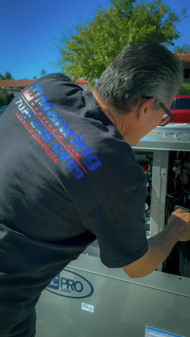Manring technician working on the electrical components of an air conditioning unit