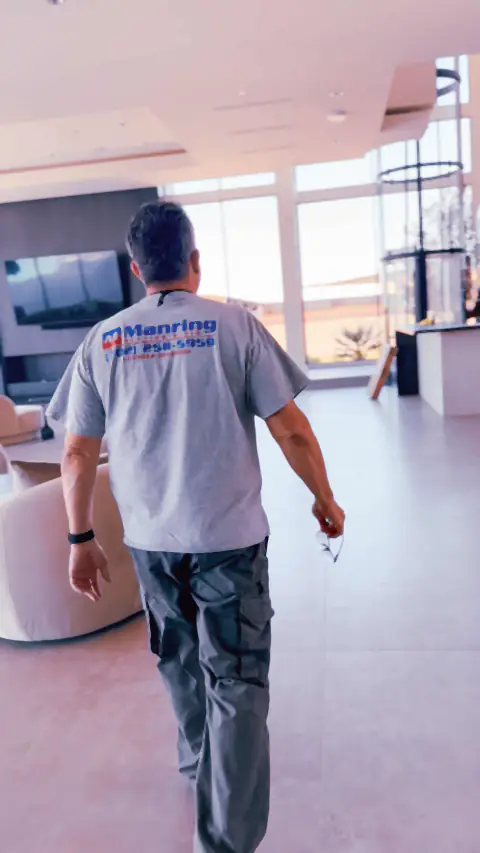Manring technician walking through a bright, modern Las Vegas home